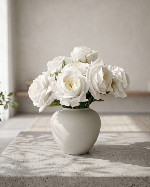 Real touch faux white rose arrangement with soft layered blooms styled in a matte ceramic vase on a concrete surface #white