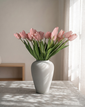 Real touch pink faux tulips in a matte off-white ceramic vase styled on a marble table for modern home decor #baby-pink 