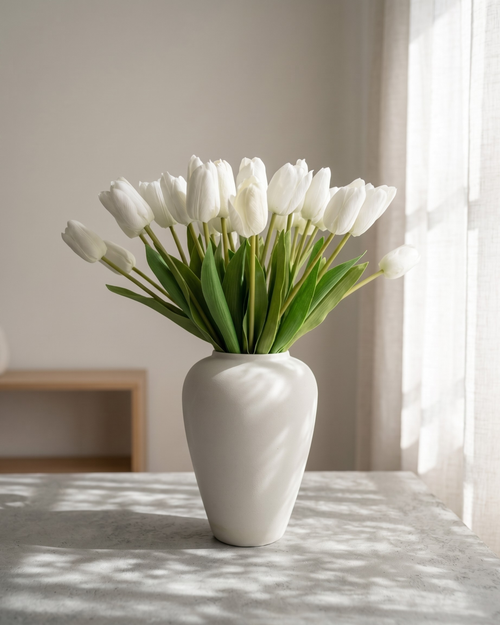 Real touch white faux tulips in a matte off white ceramic vase styled on a marble table for modern home decor #white