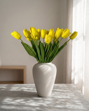 Real touch yellow faux tulips in a matte off-white ceramic vase styled on a marble table for modern home decor #yellow 