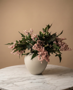 Real touch pink faux berry arrangement with green foliage in a minimalist ceramic vase on a marble table #pale-pink