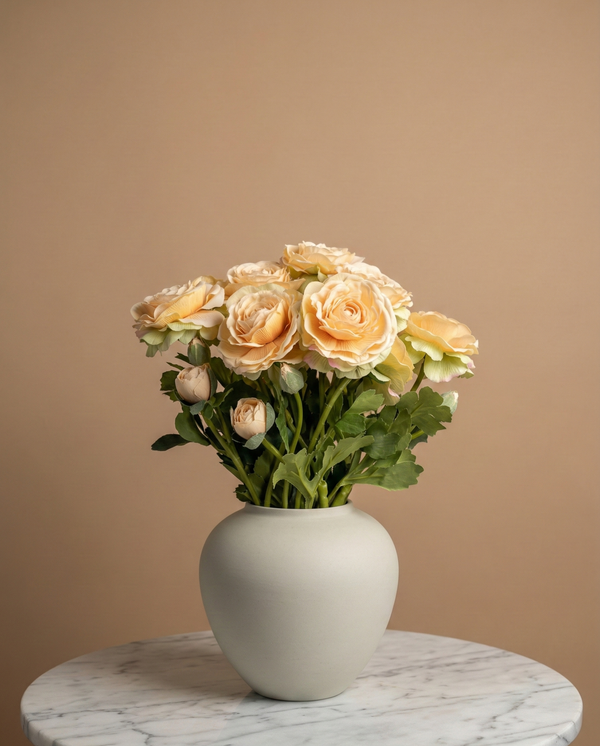 Realistic real touch peach coloured faux ranunculus arrangement in a matte ceramic vase styled on a marble table #soft-peach 