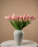 Real touch pink faux tulips in a matte off-white ceramic vase styled on a marble table for modern home decor #baby-pink 