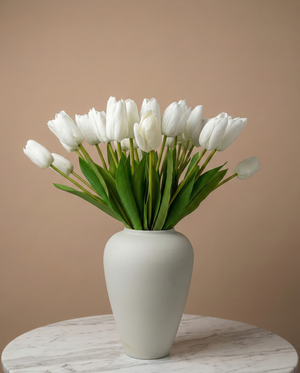 Real touch white faux tulips in a matte off white ceramic vase styled on a marble table for modern home decor #white
