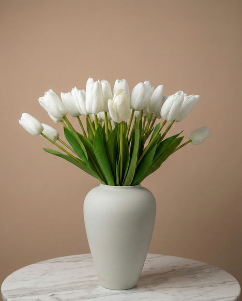 Real touch white faux tulips in a matte off white ceramic vase styled on a marble table for modern home decor #white
