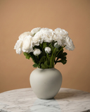 Realistic real touch white faux ranunculus arrangement in a matte ceramic vase styled on a marble table #white 
