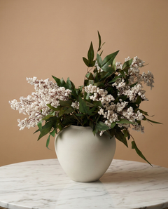 Real touch white faux berry arrangement with green foliage in a minimalist ceramic vase on a marble table #white