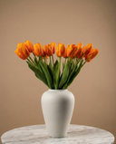 Real touch apricot orange faux tulips in a matte off white ceramic vase styled on a marble table for modern home decor #apricot-orange
