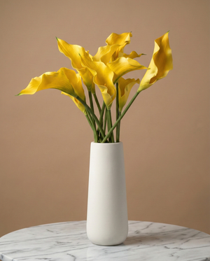 Real touch artificial yellow calla lily arrangement in a white ceramic vase on marble surface #yellow