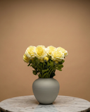 Realistic real touch yellow faux ranunculus arrangement in a matte ceramic vase styled on a marble table #yellow