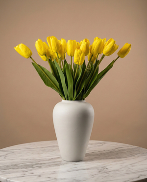Real touch yellow faux tulips in a matte off-white ceramic vase styled on a marble table for modern home decor #yellow 