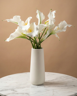 Real touch artificial white calla lily arrangement in a white ceramic vase on marble surface #white