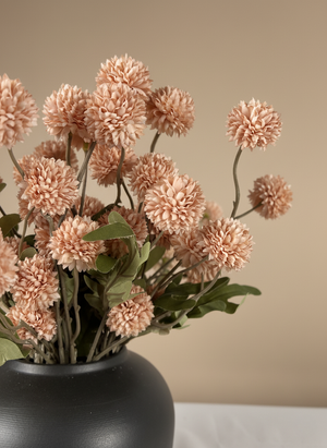 Close up of pink real touch faux pompom flowers with delicate textured blooms arranged in a ceramic vase #light-pink