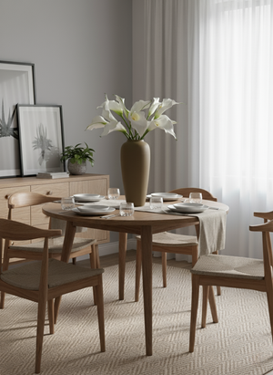 Artificial white calla lilies in a white ceramic vase, styled on a bedside table in a modern bedroom #white
