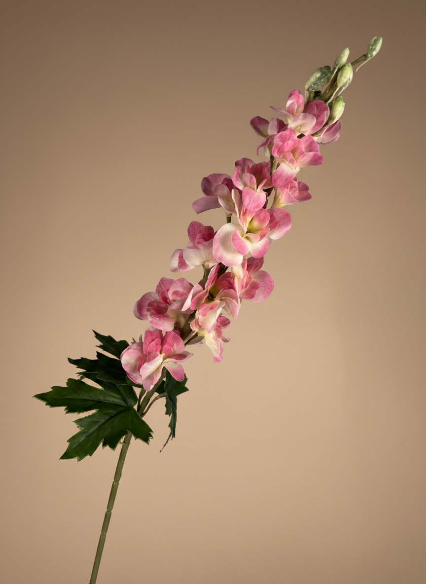 Realistic faux pink delphinium stems arranged in a white ceramic vase against a warm neutral backdrop #pink