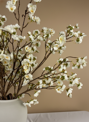 Close-up of white faux cherry blossom branches in ceramic vase, realistic artificial flowers for modern home decor #white