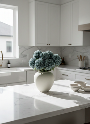 Realistic teal pompom faux flowers in a ceramic vase, styled as modern kitchen island home decor #teal