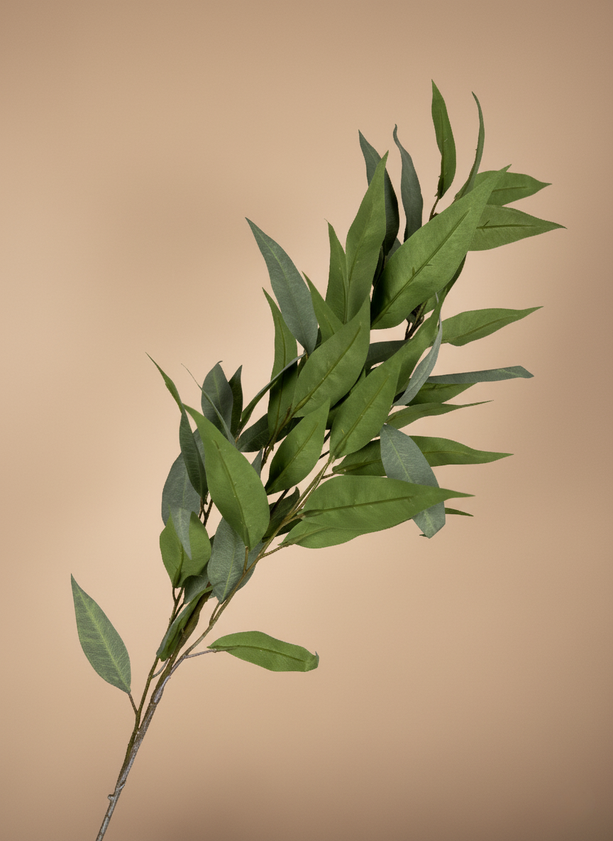 Real touch faux eucalyptus stems arranged in neutral ceramic vase on marble table