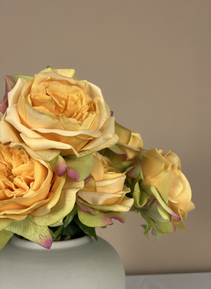 Lifelike faux orange rose blooms with layered petals styled in a minimalist ceramic vase #apricot-orange 