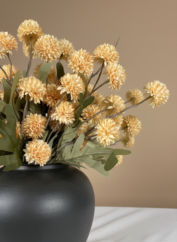 Close up of pale peach real touch faux pompom flowers with delicate textured blooms arranged in a ceramic vase #pale-peach