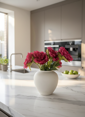 Luxury fuchsia pink artificial peonies styled in ceramic vase on modern kitchen bench top #fuchsia-pink