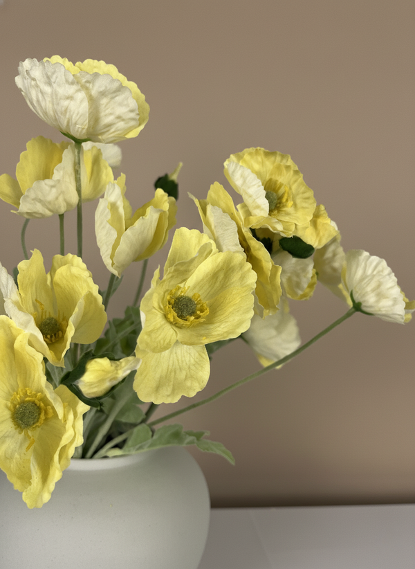 Close-up of vibrant luxury real touch faux yellow poppy flowers with realistic centres in a white ceramic vase #yellow