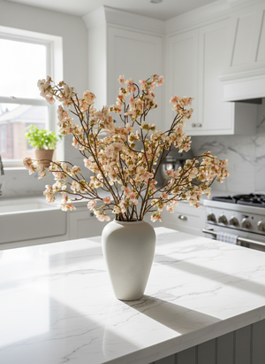 Real touch pink cherry blossoms in a white vase on a marble island in a modern home decor kitchen setting #blush-pink
