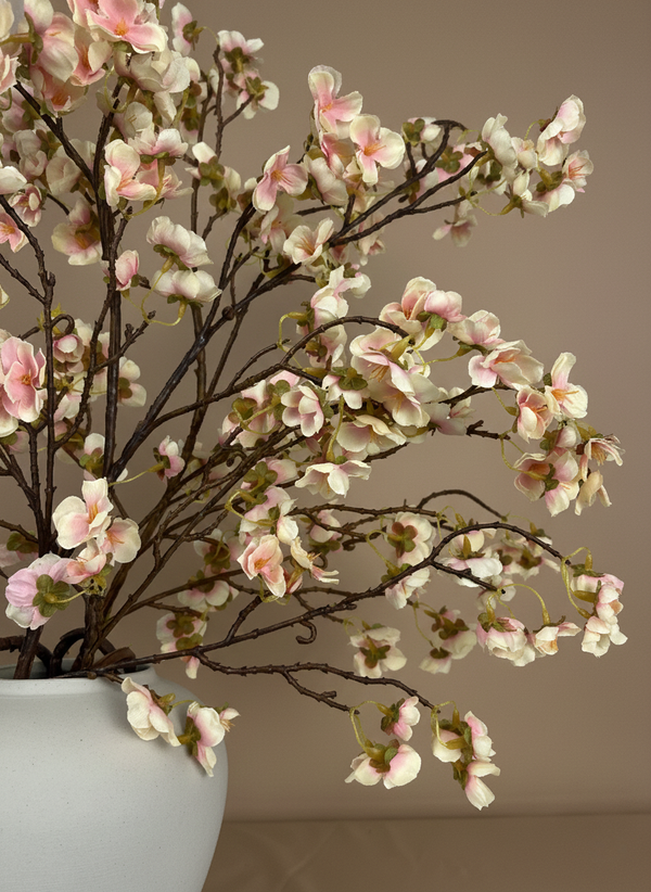 Close-up of pink faux cherry blossom branches in ceramic vase, realistic artificial flowers for modern home decor #blush-pink
